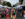 Crowds browse art and crafts at the Manayunk Arts Festival, walking between rows of white vendor tents lining Main Street.