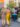 Two women walk past the Singing Fountain on East Passyunk Avenue, surrounded by shops, restaurants and people enjoying the neighborhood.
