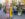 Two women walk past the Singing Fountain on East Passyunk Avenue, surrounded by shops, restaurants and people enjoying the neighborhood.