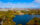 An aerial view of FDR Park in South Philadelphia, with tree-lined streets, a lake and the Center City skyline in the distance.