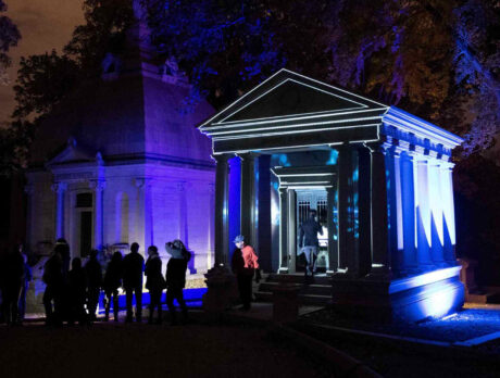Visitors gather outside an illuminated mausoleum at Laurel Hill Cemetery during the Soul Crawl nighttime tour.