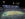A packed football stadium glows under stadium lights as fans cheer on the Philadelphia Eagles, with green and white fireworks streaking above in the dark sky.