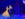 Actors dressed as Belle and the Beast dance together onstage, framed by a magical backdrop of a gate and moonlit night sky.