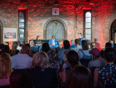 Three people talk on a stage at Eastern State Penitentiary in Philadelphia during the TED Democracy Fireside Chat in 2024