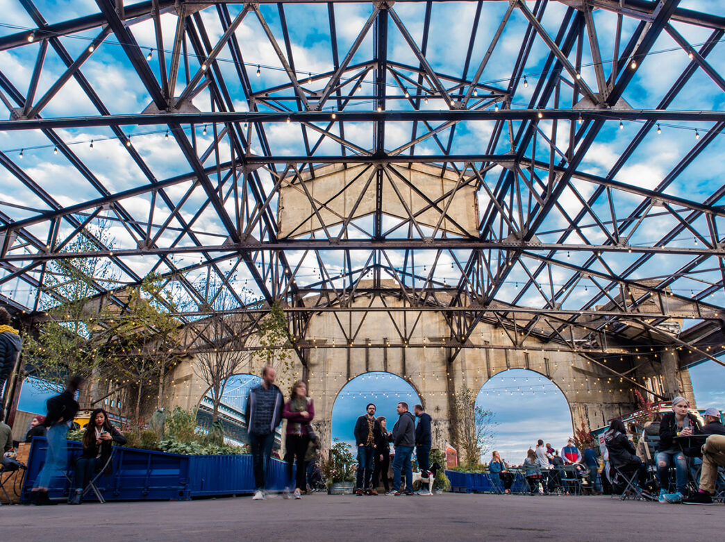 People walking through the outdoor garden at Cherry Street Pier