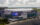 A drone photo of the sleek, modern Xfinity Mobile Arena with glass walls, flags flying out front and a bright purple marquee.