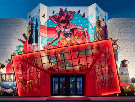 The exterior of Netflix House with a large red entrance canopy and mural showcasing Netflix characters and symbols.