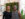 Two smiling owners of Plant & People stand inside their bright, plant-filled shop, surrounded by greenery, gifts and natural light streaming through the windows.