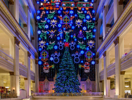 A towering Christmas tree and dazzling wall of holiday lights fill a large atrium in the Wanamaker building in Philadelphia.