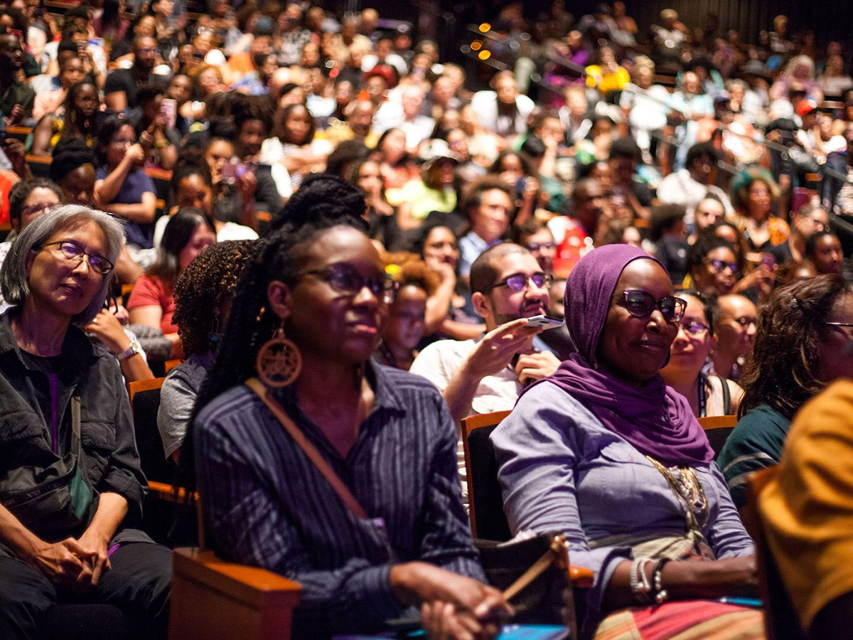 A crowd of BlackStar audience members sitting to watch a film screening