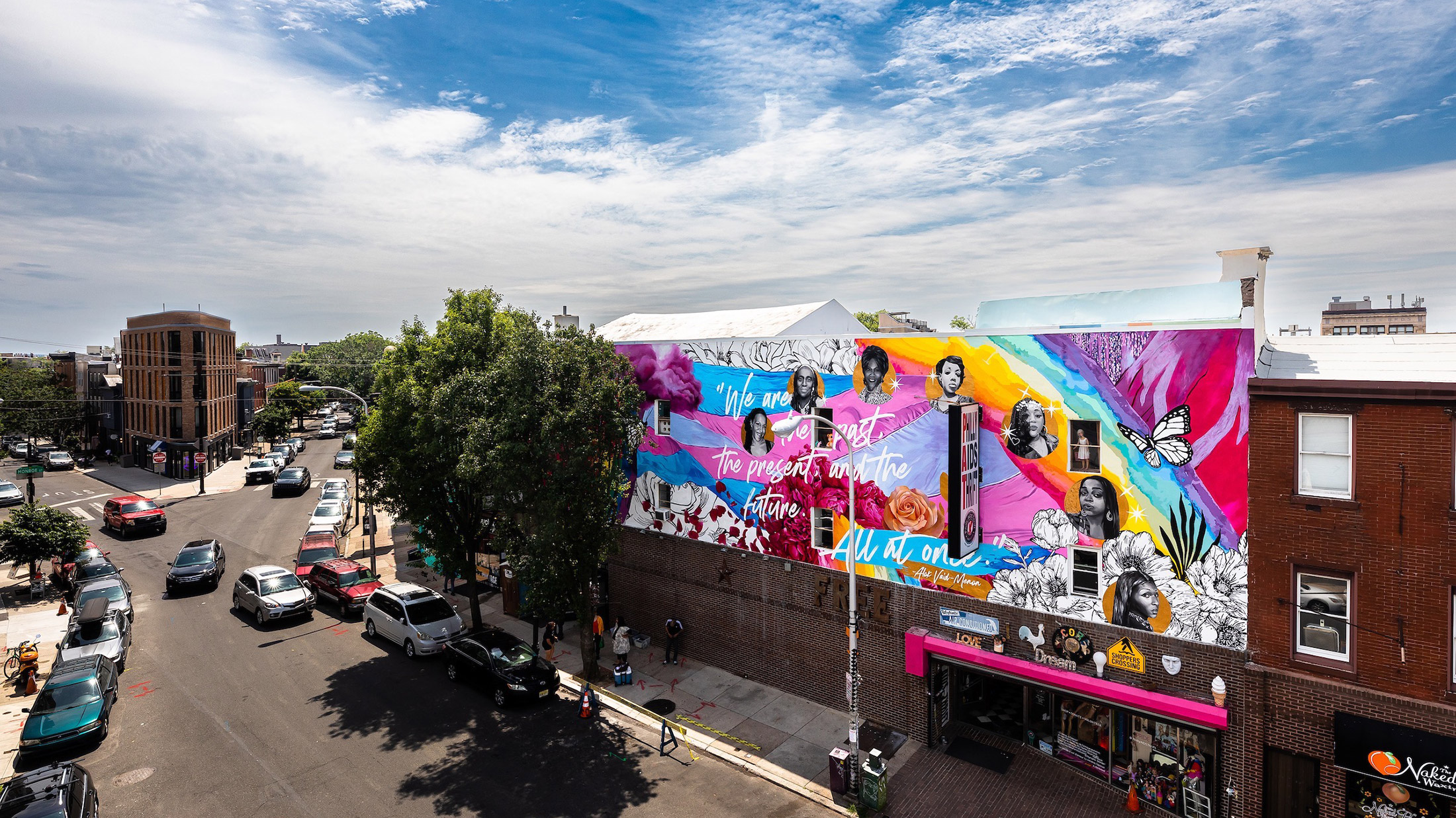 A colorful mural depicting the history of trans women sits above Philly Aids Thrift in Queen Village
