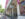 The historic Doylestown Inn features a covered sidewalk patio with outdoor seating, hanging signs and American flags lining the façade as visitors dine and stroll along the tree-lined street.
