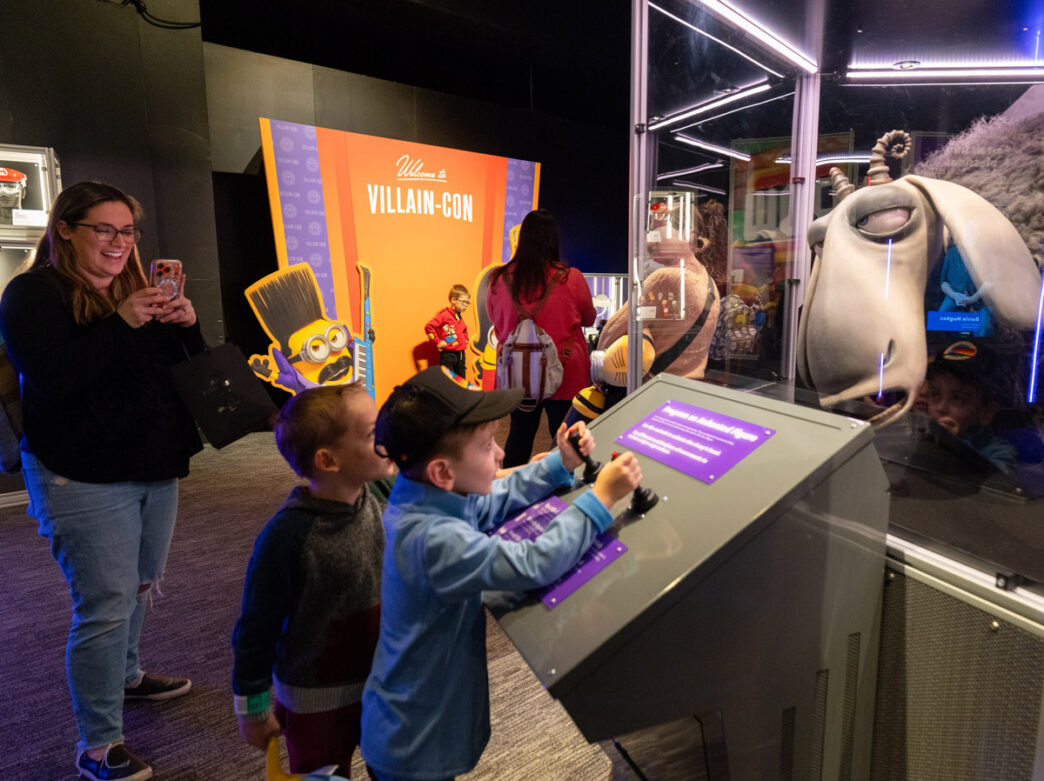 Visitors play at the Universal Theme Parks exhibit at the Franklin Institute.