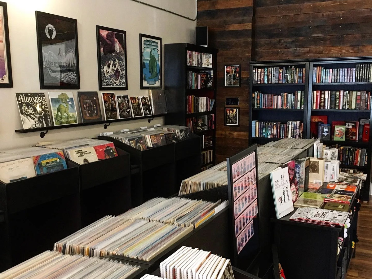 The selection of vinyl records at Hop Fidelity in West Chester, Pennsylvania, in bins and stand-up displays, with a bookshelf in the background.