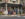 A man and two couples stand outside of a clothing store at the corner of Main and Bridge Streets in New Hope.