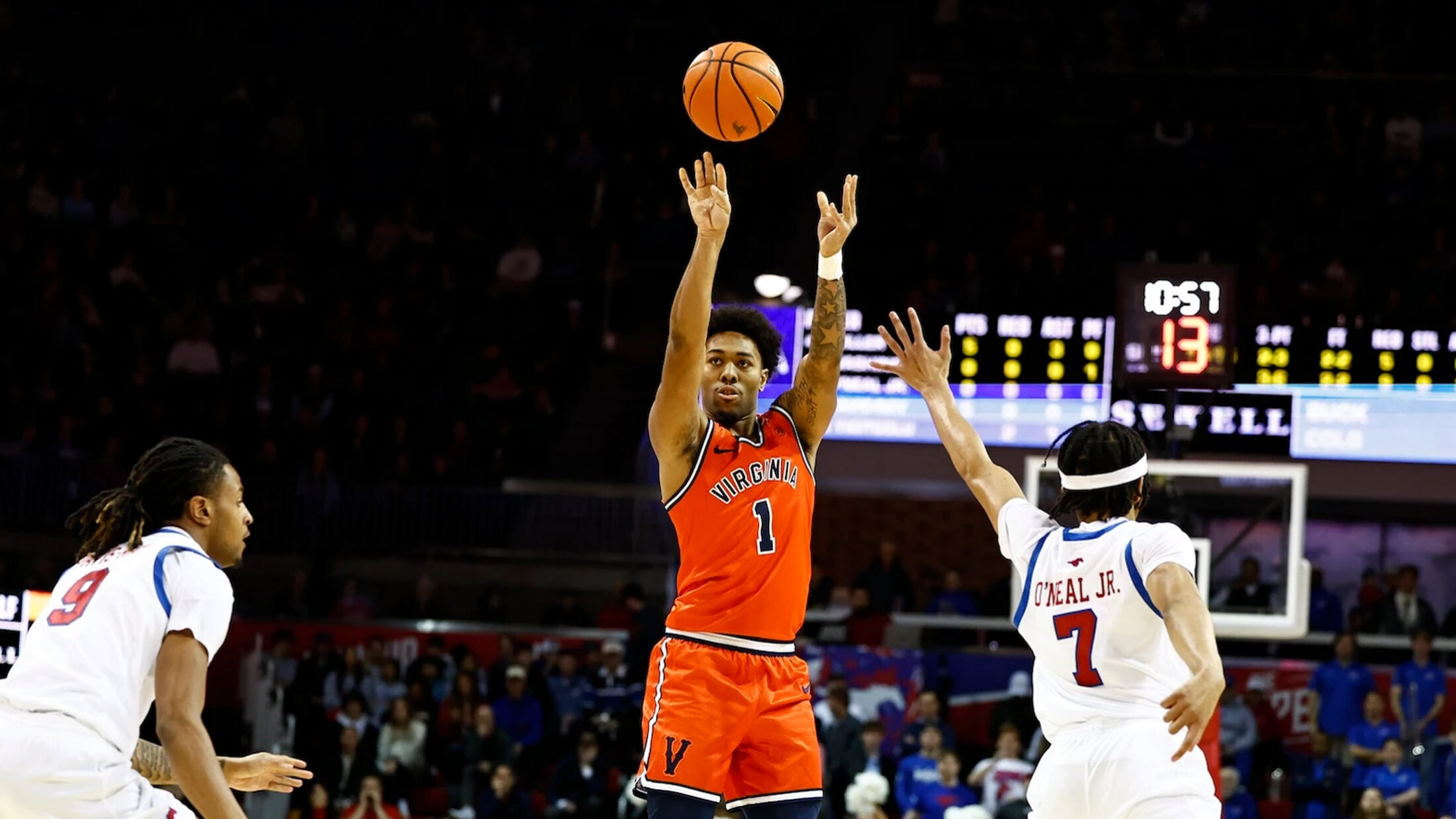 Virginia's Malik Thomas shoots over two defenders in his team's 72-68 win over Southern Methodist University.
