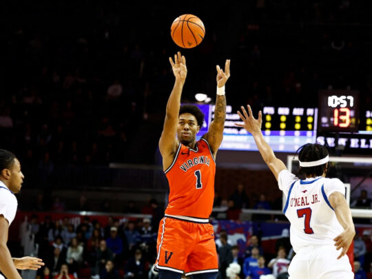 Virginia's Malik Thomas shoots over two defenders in his team's 72-68 win over Southern Methodist University.