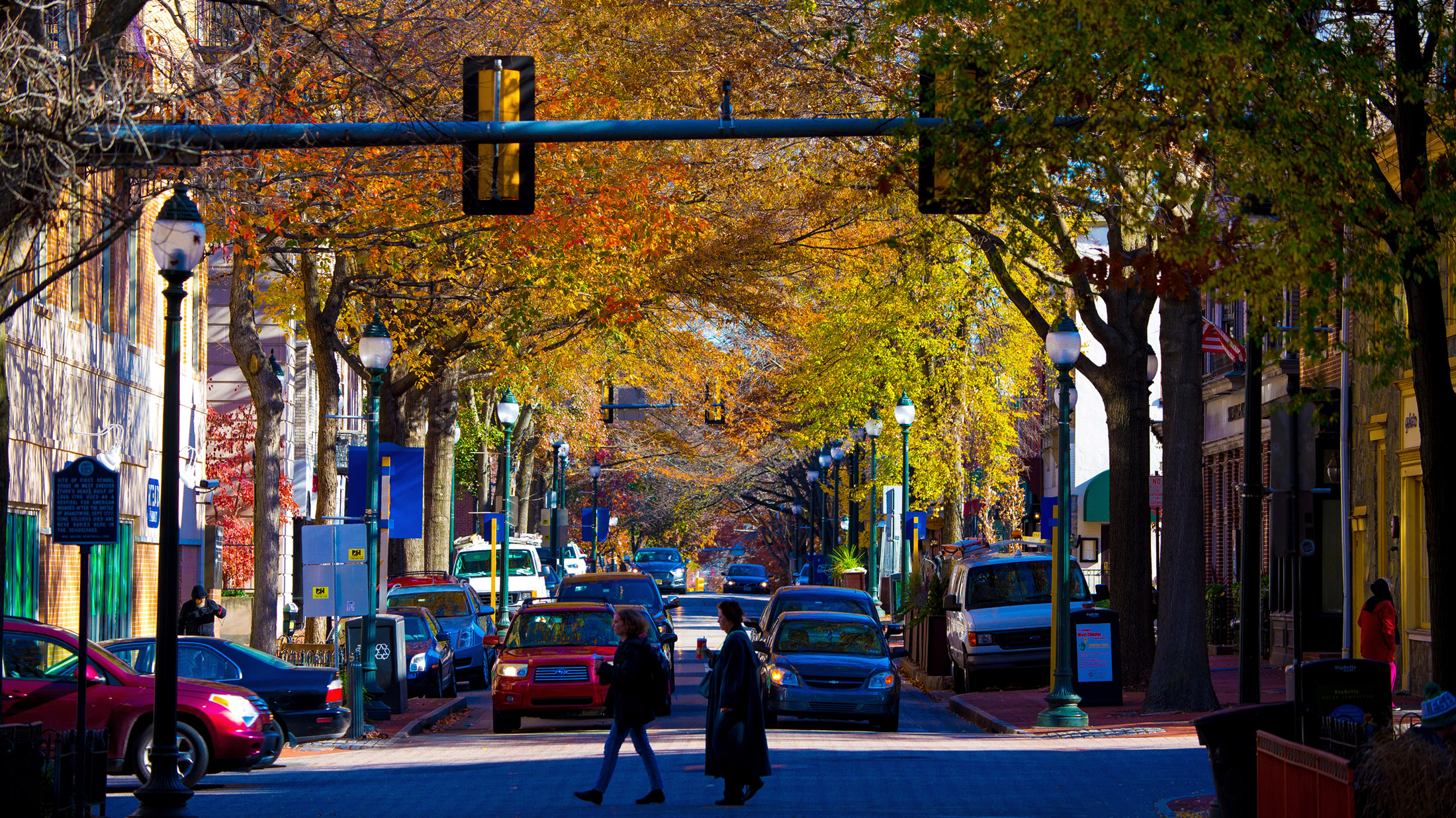 People cross the street in downtown West Chester