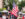 A gentleman in military dress attire carries a large American flag through the crowd at the Philadelphia Juneteenth Festival in Germantown.