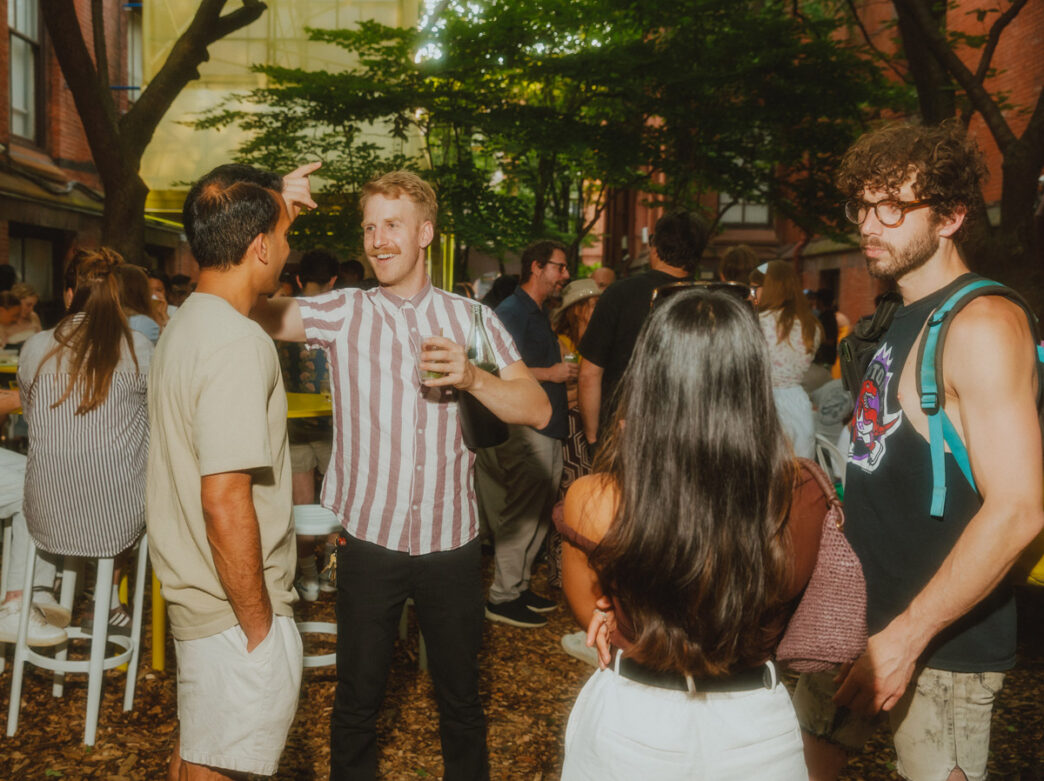 People gather and chat outdoors over drinks at Frankie's Summer Club.