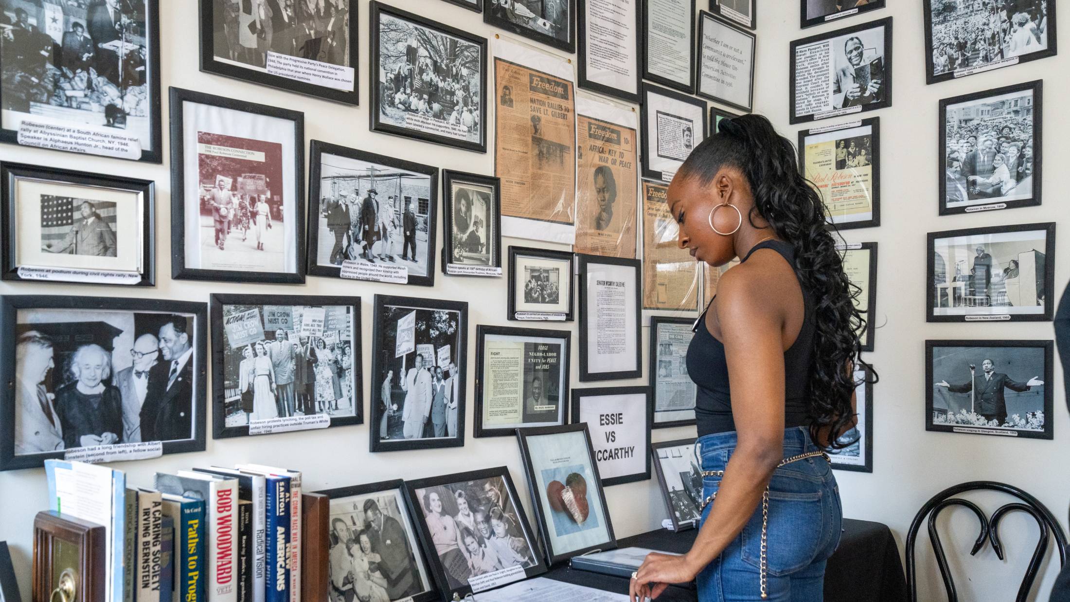 A visitor looks at photos and news clippings on display at the Paul Robeson House in West Philadelphia.