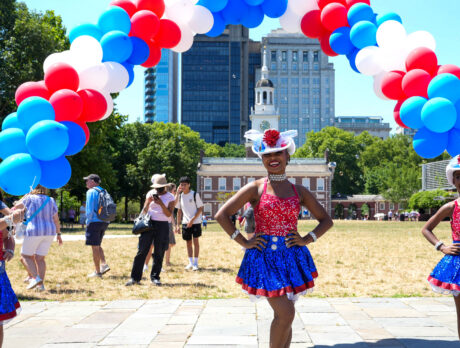 Three people in patriotic outfits in front of Independence Hall during the Red White & Blue To Do.