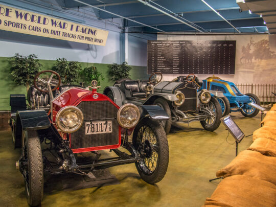 A visitor at the Simeone Foundation Auto Museum looks at racing cars from the pre-WWI era.