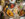Overhead view of a table at Veda in Philadelphia filled with colorful Indian dishes, including curries, rice, and small plates, alongside cocktails and wine being shared among diners.