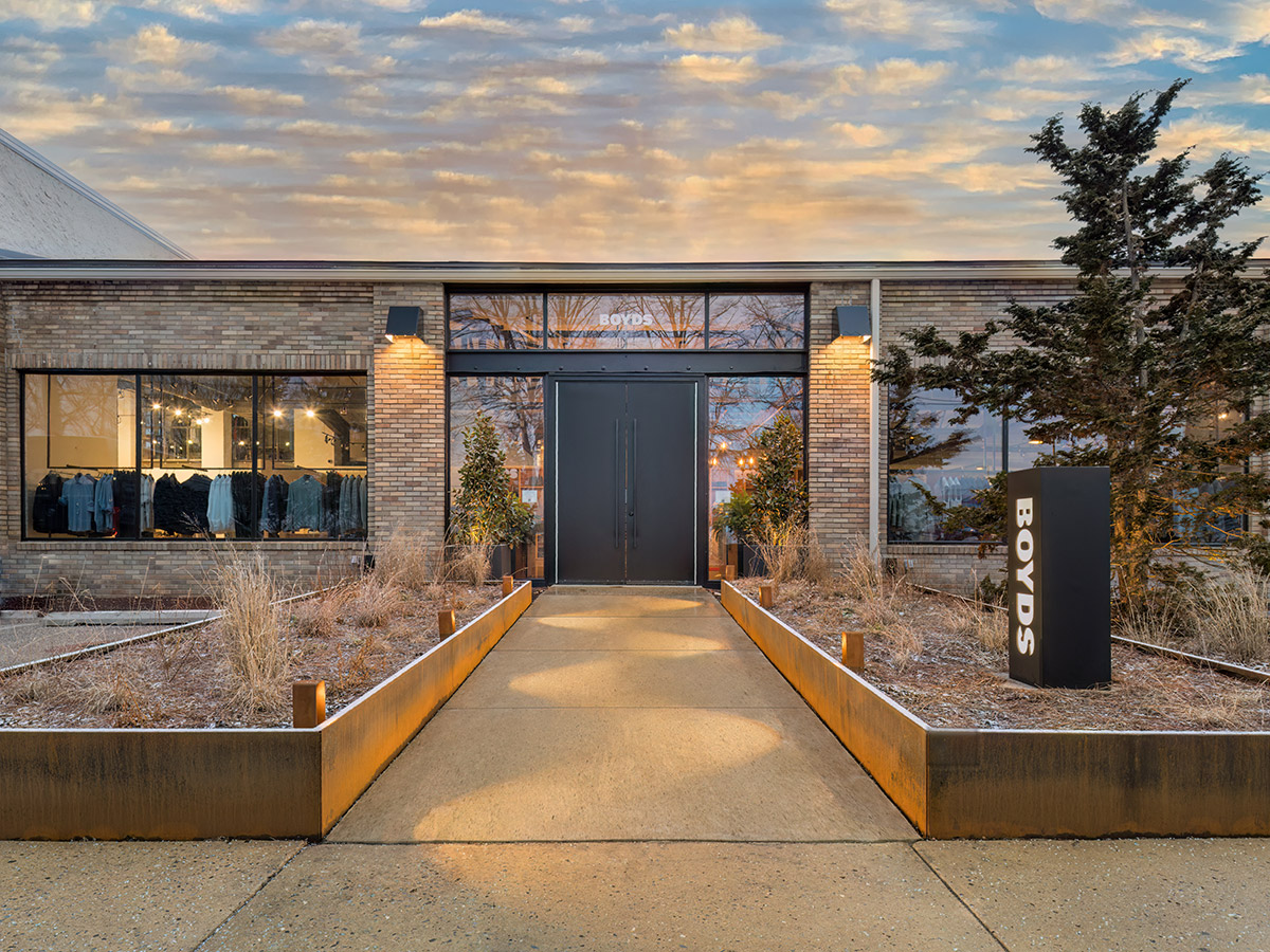The exterior of a luxury clothing store, Boyds Wayne, with a sky in the backdrop during sunset