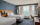 Een helder verlichte hotelkamer met blauwe tapijten en muren, met twee tweepersoonsbedden in het Courtyard Philadelphia South at The Navy Yard