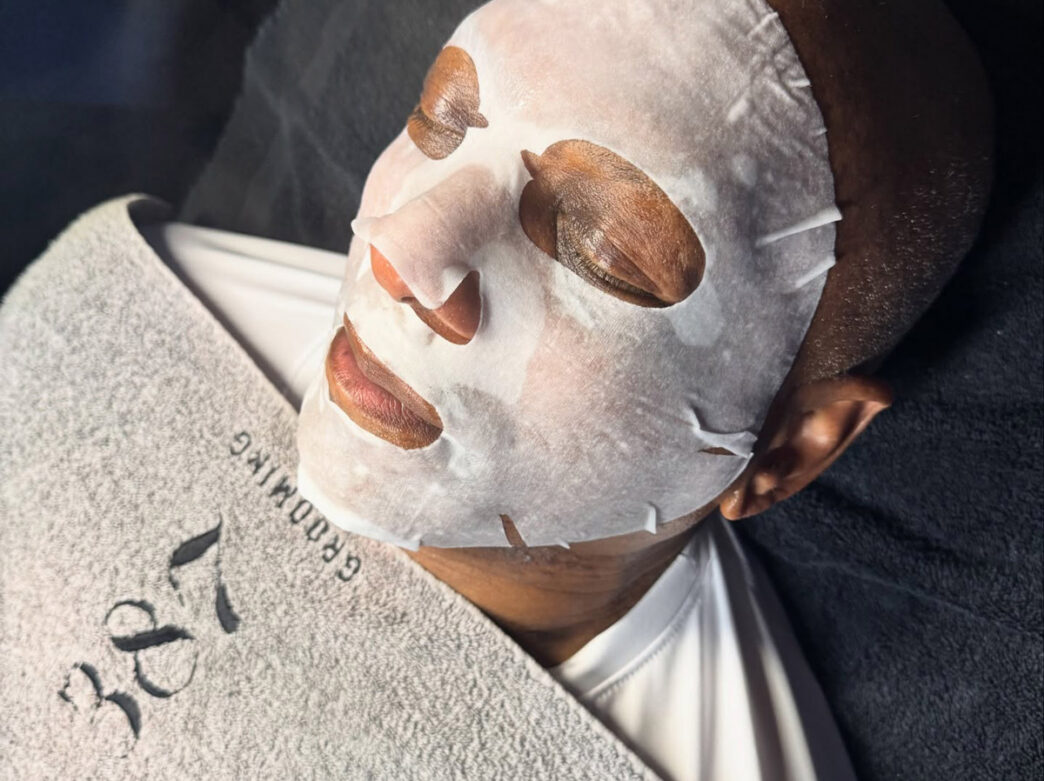 A man wears a white facemask as part of a skincare treatment at 387 Grooming in Philadelphia.