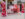 Un letrero rojo y rosa dentro de un centro comercial dice "Philly Love Stories"."