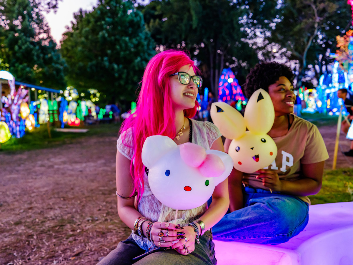 Two women hold spun-sugar treats in the form of Hello Kitty and Pikachu at the Chinese Lantern Festival in Philadelphia's Franklin Square.