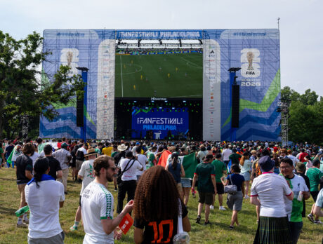 A crowd watches a giant TV screen showing World Cup soccer at FIFA Fan Fest in Philadelphia