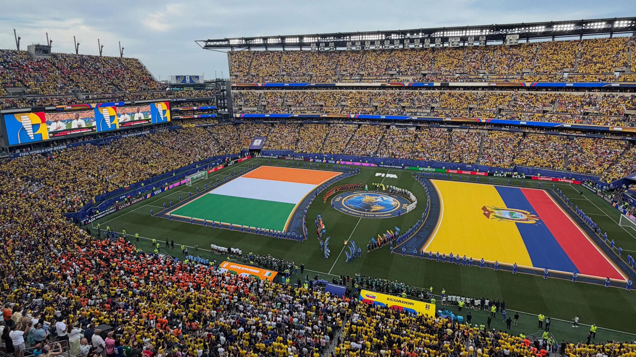 Lincoln Financial Field — known as Philadelphia Stadium for FIFA World Cup 26 — full of fans with large Côte d’Ivoire and Ecuador flags on the field during the pre-match national anthems and handshake
