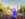 A performer stands on stage facing a large crowd during a July 4th concert on Philadelphia’s Benjamin Franklin Parkway with thousands of attendees filling the tree-lined boulevard and a view of Center City in the background.