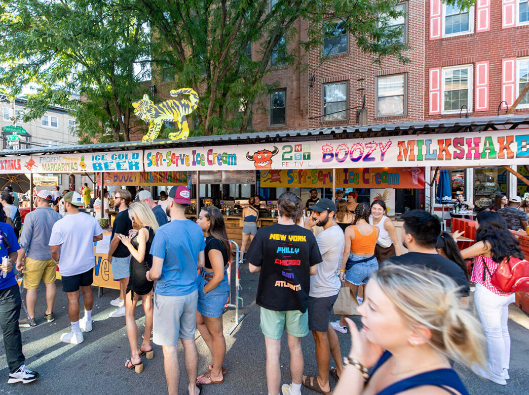 Festivalgoers line up at a food stand selling soft-serve ice cream, frozen margaritas and more during the annual 2nd Street Festival.