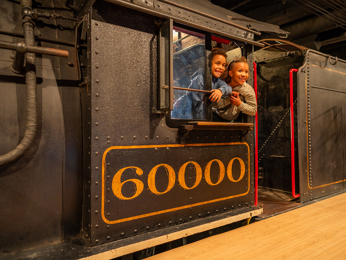 Children hitch a ride on the 60000 steam locomotive inside the Hamilton Collections Gallery at The Franklin Institute.