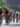 A pack of professional cyclists wearing helmets, sunglasses and cycling jerseys races down the Benjamin Franklin Parkway during the Philadelphia Cycling Classic.