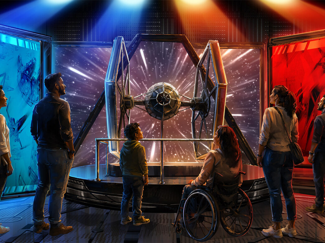 Een weergave van de ‘Wireframe Worlds’-galerij in de nieuwe Star Wars-tentoonstelling bij The Franklin Institute. Mensen staan rond een TIE-fighter-display onder rode en blauwe lampen.
