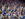 Sixers fans — many dressed in blue Sixers jerseys and T-shirts — go wild in the stands.
