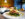A grilled piece of salmon topped with a lime wedge is served over mashed potatoes and green beans in a creamy sauce.