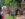 Visitors stroll through Peddler's Village during Scarecrows in the Village, with colorful scarecrows, fall decorations and American flags lines the brick walkway.