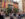 Crowds gather in a car-free street decorated with pride flags at the annual Ourfest celebration.