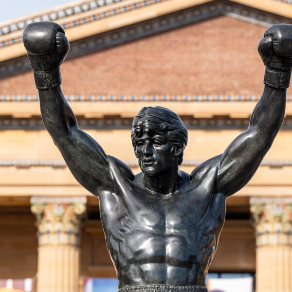 The bronze Rocky Statue raises both boxing-gloved fists in victory in front of the Philadelphia Museum of Art.