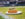 A loaded, crispy-coated baked potato topped with macaroni and cheese, sauce and chopped chicken cutlet sitting on a white plate on the field at Lincoln Financial Field.
