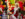 Mrs. Claus smiles and greets two young visitors wearing red plaid pajamas while seated on an ornate velvet red-and-gold throne surrounded by festive holiday decorations.
